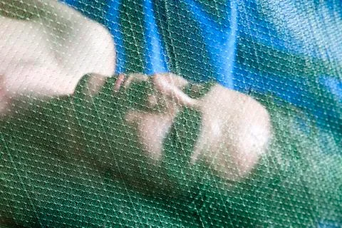 Malaysia, Man with mosquito net, close up Stock Photos