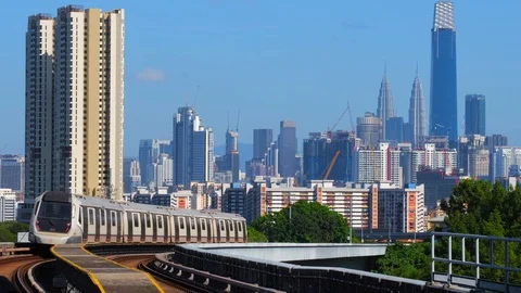 Malaysia Mass Rapid Transit (MRT) train with a background of Kuala Lumpur city Stock Footage 129246176