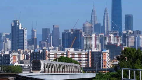 Malaysia Mass Rapid Transit (MRT) train with a background of Kuala Lumpur city Stock Footage 129250497