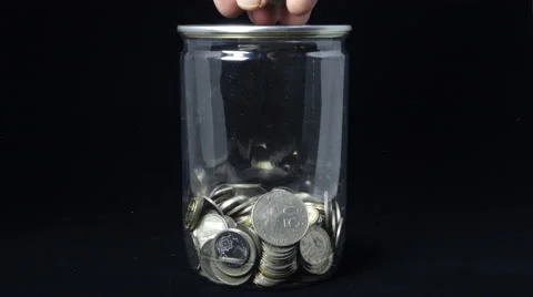 Malaysia Ringgit coins falls into a jar. Black Background. 4k Video. Stock Footage 56193688