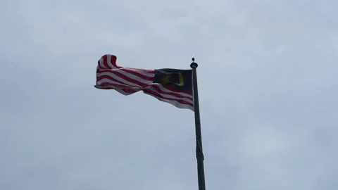 Malaysian flag flying in bright sunshine Stock Footage