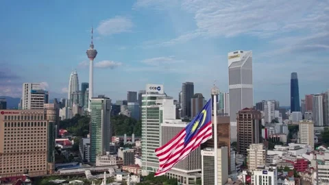 Malaysian Flag Waving In Wind With Kuala Lumpur Skyline Background Video stock 336596117
