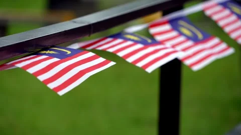 Malaysian flags hanging from a rail Stock Footage 330761932