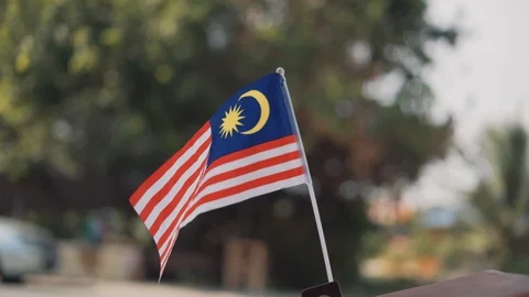 Malaysian mini flag or Jalur gemilang waving with blurred background. Stock Footage 93800053