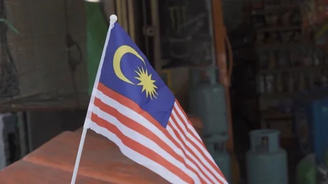 Malaysian mini flag or Jalur gemilang waving with blurred background. Stock Footage 93814747