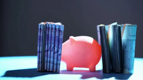 Malaysian ringgit currency bills with piggy bank rotating slowly Video stock 333810660