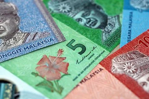 Malaysian ringgit paper banknotes pile on table. Malaysia MYR currency money Stock Photos