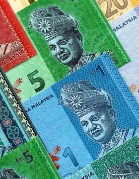 Malaysian ringgit paper banknotes pile on table. Malaysia MYR currency money Stock Photos
