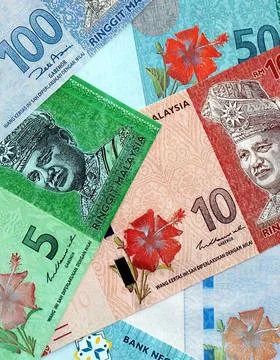 Malaysian ringgit paper banknotes pile on table. Malaysia MYR currency money Stock Photos
