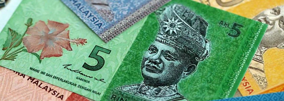 Malaysian ringgit paper banknotes pile on table. Malaysia MYR currency money Stock Photos