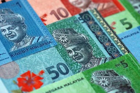 Malaysian ringgit paper banknotes pile on table. Malaysia MYR currency money Stock Photos