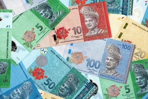 Malaysian ringgit paper banknotes pile on table. Malaysia MYR currency money Stock Photos