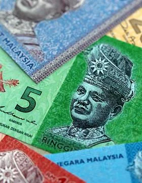 Malaysian ringgit paper banknotes pile on table. Malaysia MYR currency money Stock Photos