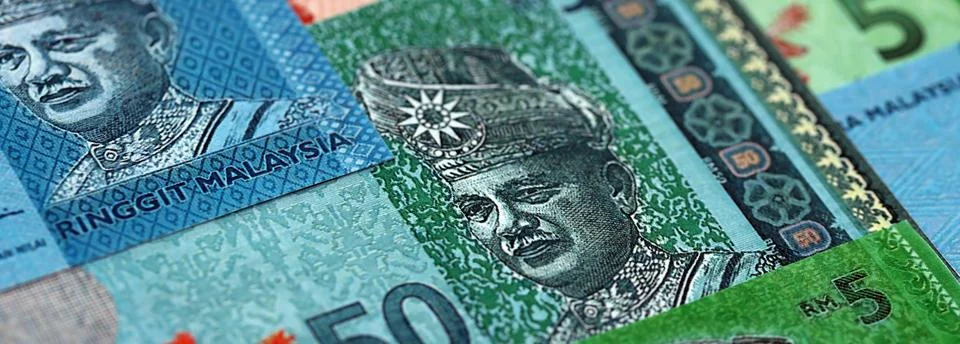 Malaysian ringgit paper banknotes pile on table. Malaysia MYR currency money Stock Photos