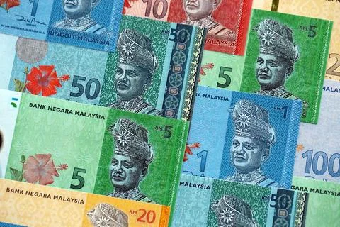 Malaysian ringgit paper banknotes pile on table. Malaysia MYR currency money Stock Photos