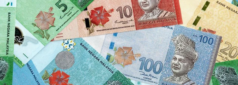 Malaysian ringgit paper banknotes pile on table. Malaysia MYR currency money Stock Photos