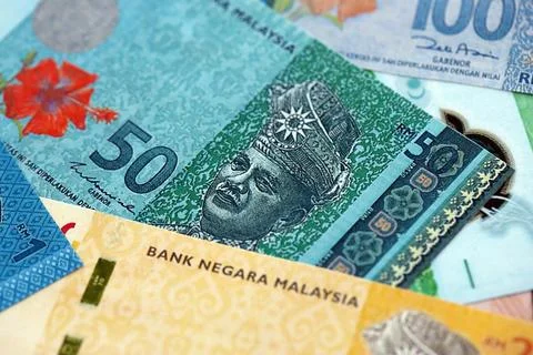 Malaysian ringgit paper banknotes pile on table. Malaysia MYR currency money Stock Photos