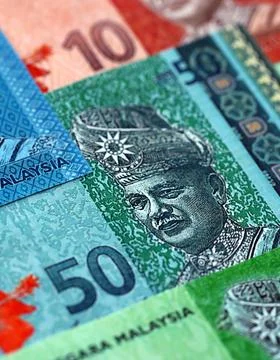 Malaysian ringgit paper banknotes pile on table. Malaysia MYR currency money Stock Photos