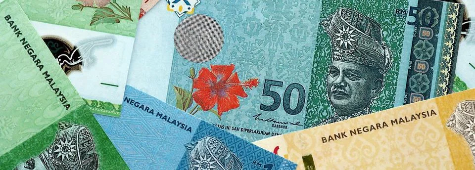 Malaysian ringgit paper banknotes pile on table. Malaysia MYR currency money Stock Photos