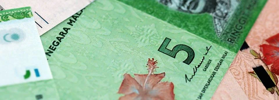 Malaysian ringgit paper banknotes pile on table. Malaysia MYR currency money Stock Photos