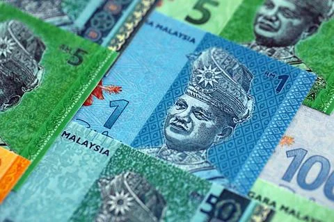 Malaysian ringgit paper banknotes pile on table. Malaysia MYR currency money Stock Photos