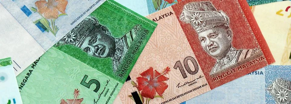 Malaysian ringgit paper banknotes pile on table. Malaysia MYR currency money Stock Photos