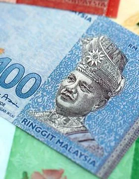 Malaysian ringgit paper banknotes pile on table. Malaysia MYR currency money Stock Photos
