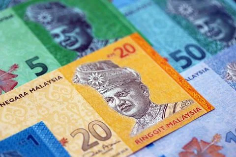 Malaysian ringgit paper banknotes pile on table. Malaysia MYR currency money Stock Photos