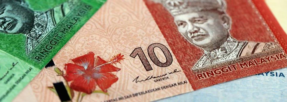 Malaysian ringgit paper banknotes pile on table. Malaysia MYR currency money Stock Photos