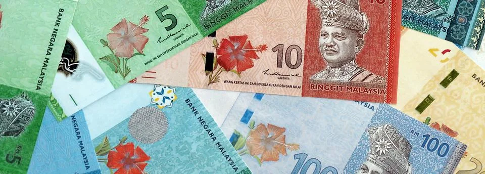 Malaysian ringgit paper banknotes pile on table. Malaysia MYR currency money Stock Photos