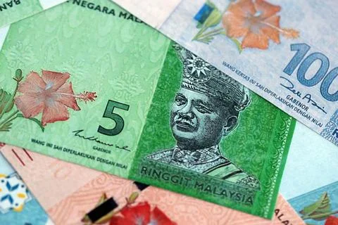 Malaysian ringgit paper banknotes pile on table. Malaysia MYR currency money Stock Photos