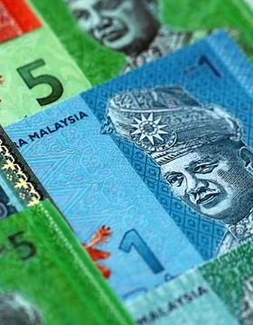 Malaysian ringgit paper banknotes pile on table. Malaysia MYR currency money Stock Photos
