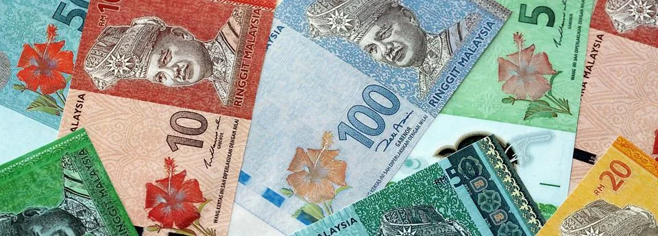 Malaysian ringgit paper banknotes pile on table. Malaysia MYR currency money Stock Photos