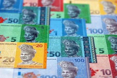 Malaysian ringgit paper banknotes pile on table. Malaysia MYR currency money Stock Photos