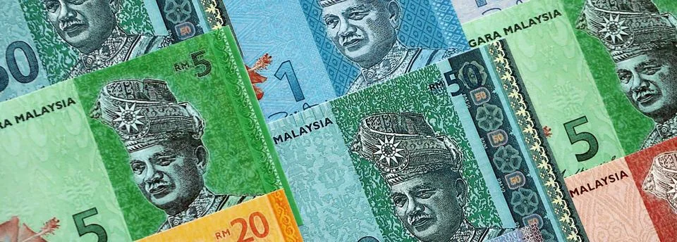 Malaysian ringgit paper banknotes pile on table. Malaysia MYR currency money Stock Photos