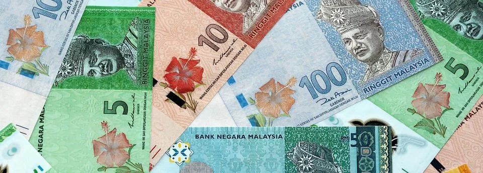 Malaysian ringgit paper banknotes pile on table. Malaysia MYR currency money Stock Photos