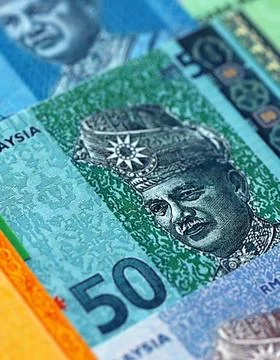 Malaysian ringgit paper banknotes pile on table. Malaysia MYR currency money Stock Photos