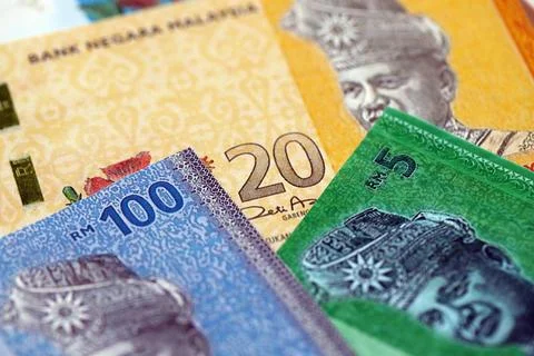 Malaysian ringgit paper banknotes pile on table. Malaysia MYR currency money Stock Photos