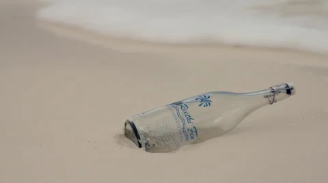 Maldives - empty glass bottle washed away on the beach shore Stock Footage 47783279
