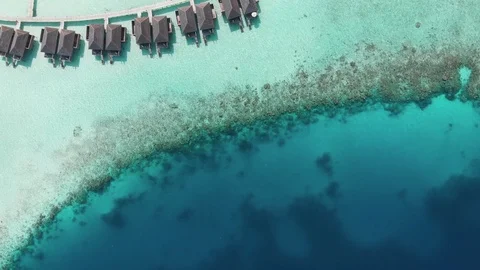 Maldives fly over sea huts in 4k Stock Footage