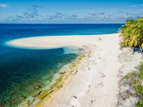 Maldives island with sandy beach and quiet ocean. Drone view Stock Photos