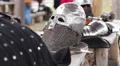 Male actors putting on plate armour, reenactment of medieval history events HD Footage