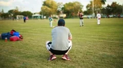 Little kid in baseball uniform watching , Stock Video