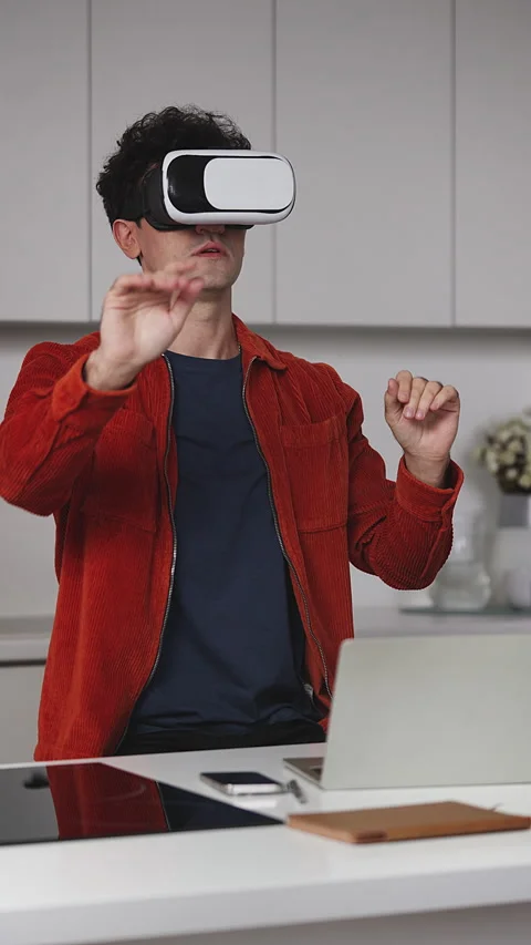 Male AI developer testing video game in virtual reality headset, correcting bugs Stock Footage 341017885
