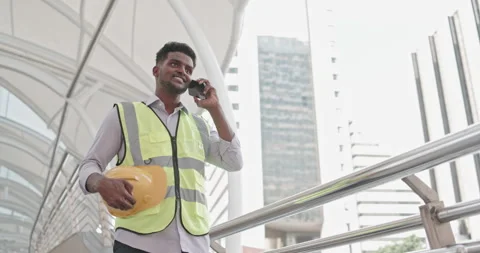 Male American engineer standing using tablet to inspect building construction Stock Footage 259813709