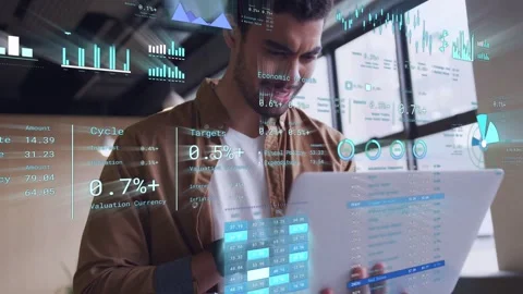 Male analyst holding tablet tapping phone updating holo charts analyzing % stats Stock Footage 333790439