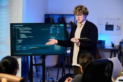 Male Analyst Presenting Cybersecurity Data in Modern Office Stock Photos