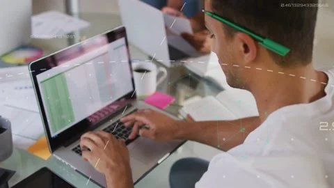 Male analyst typing and tapping spreadsheet, starting green cell animations for Stock Footage 332881942