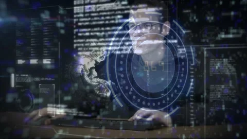 Male analyst typing on keyboard or mouse in dim control room, analyzing data, Stock Footage 329702954
