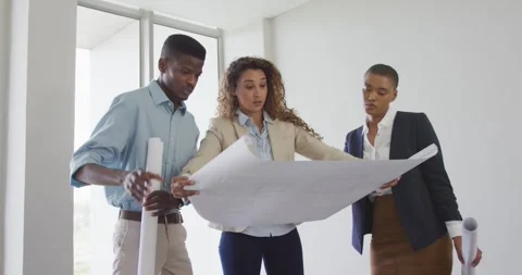 Male and female architects checking architects plans in modern office Stock Footage 336844002
